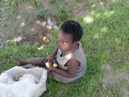 african girl cutting potatoes